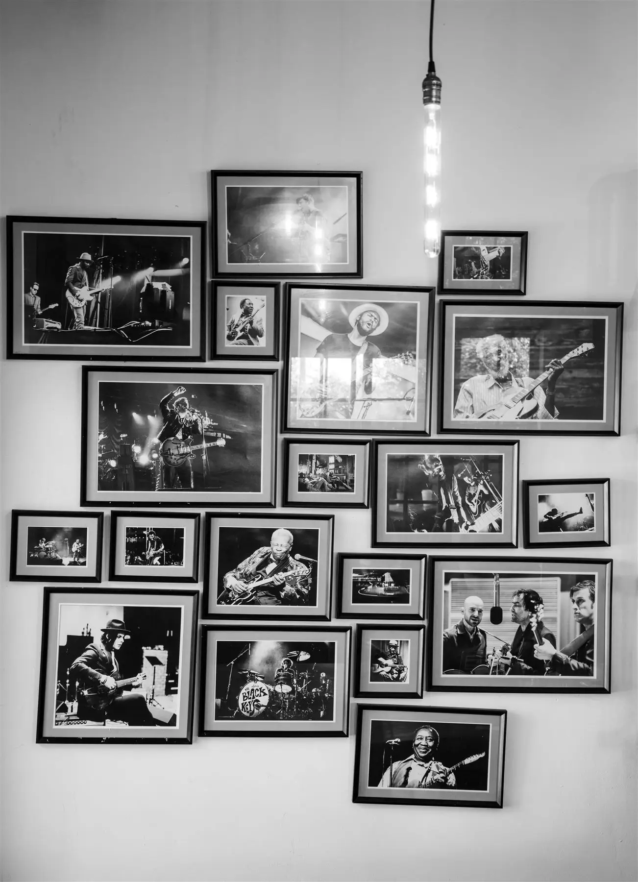 Wall of framed music photographs at The Upper Millstone