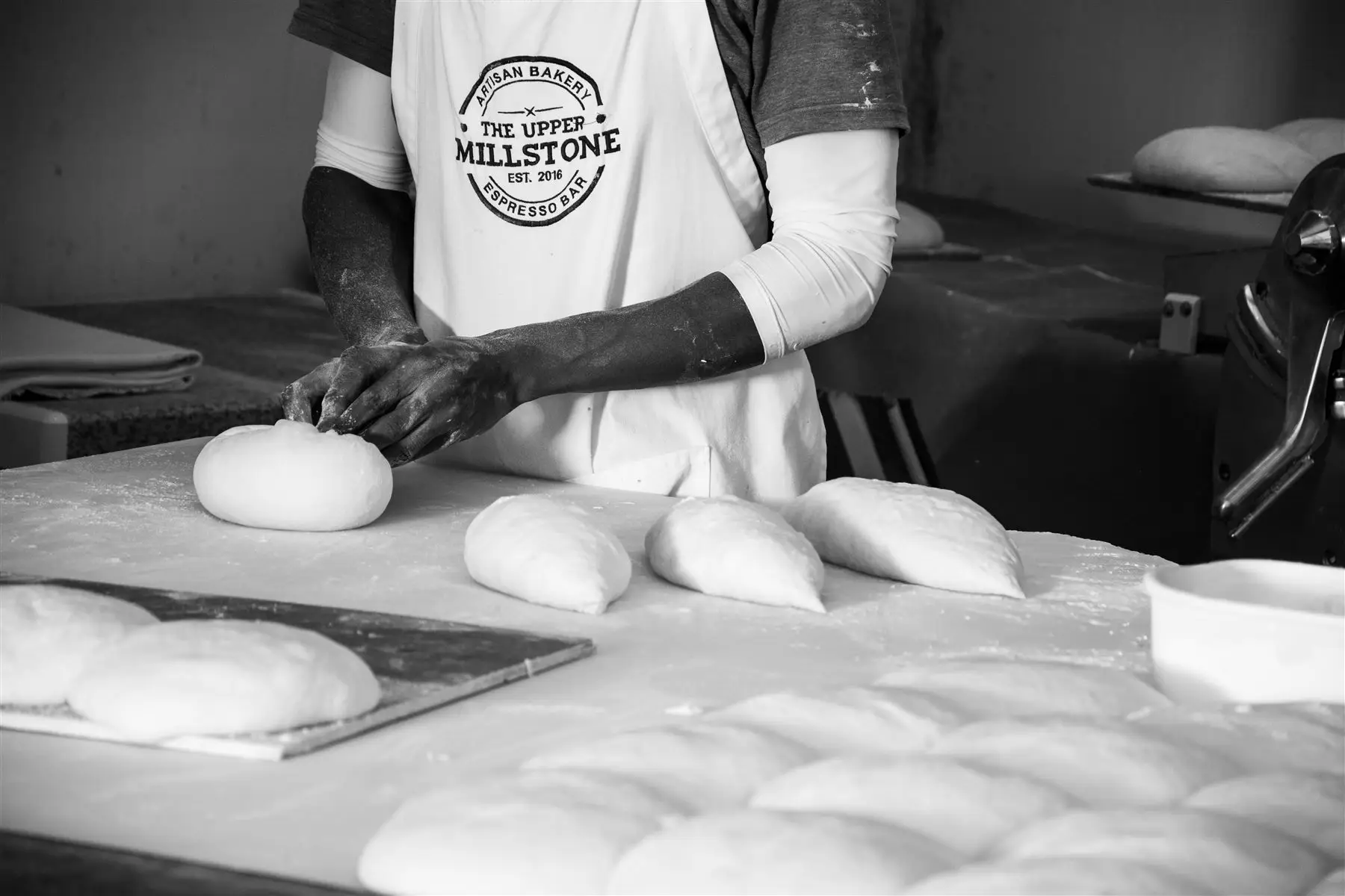 Hands shaping sourdough by hand, early morning bake